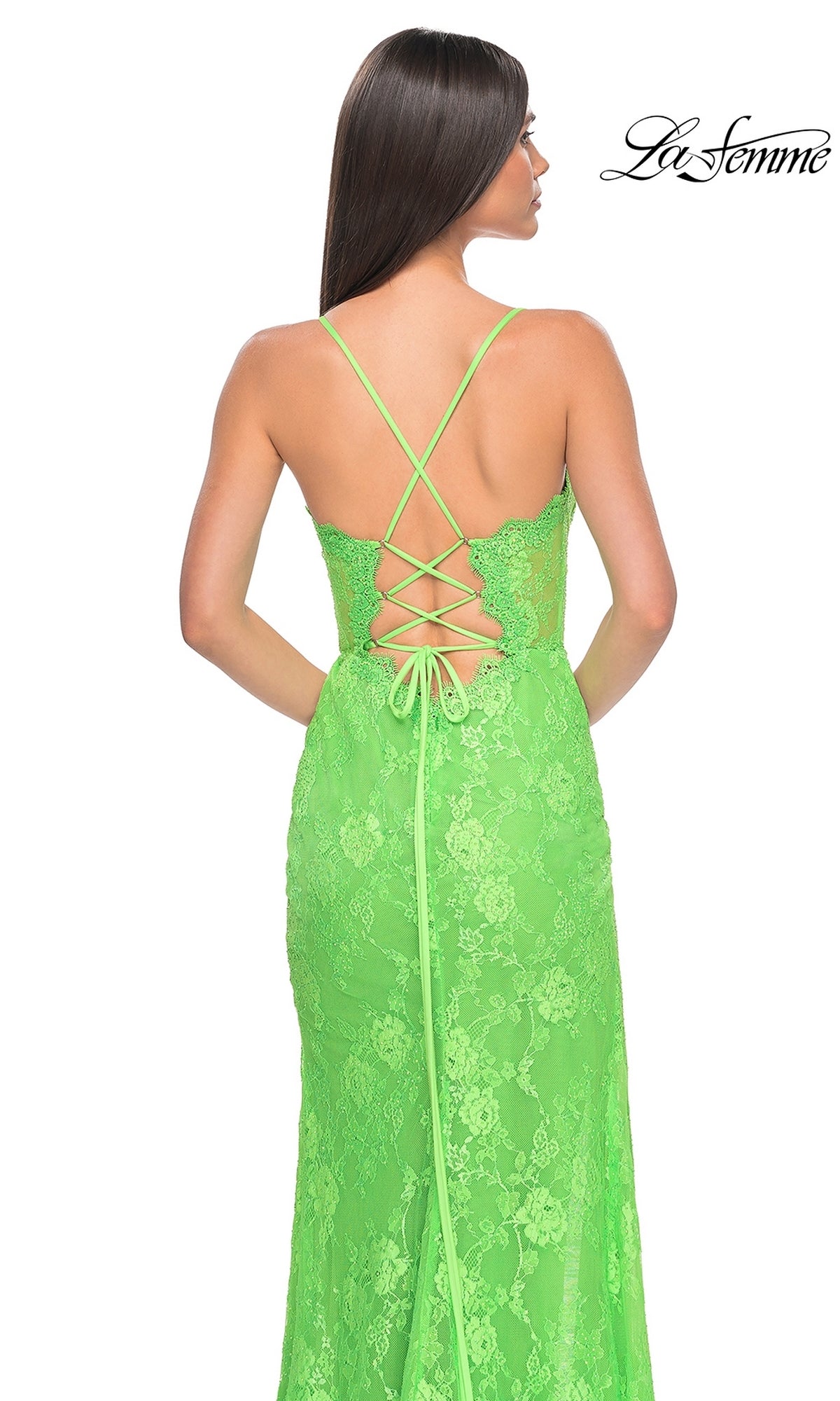 Woman wearing the La Femme Bright Long Lace Prom Dress 32441 with spaghetti straps and a crisscross lace-up back, standing against a plain white background.
